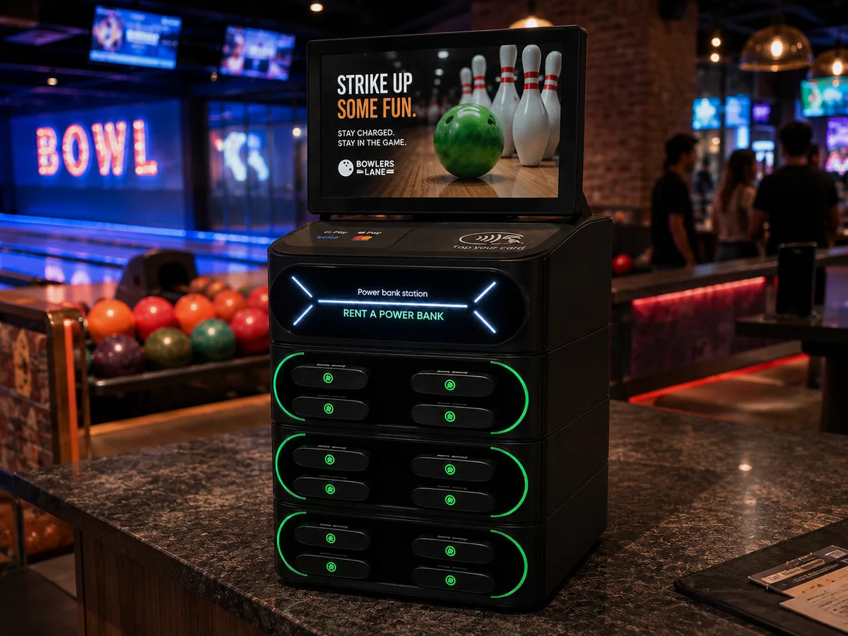Voltage Nexus kiosk at a bowling alley with lanes in the background